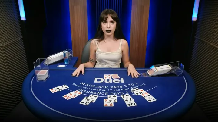 Nelli at the Duel Blackjack table, hands on the blue felt